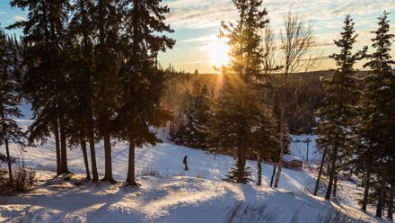 Sunset and skier going down the mountain